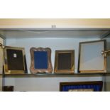 Four large silver plated photograph frames.