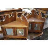 A pair of walnut small hanging corner cupboards.