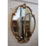 A decorative gilt framed mirror.