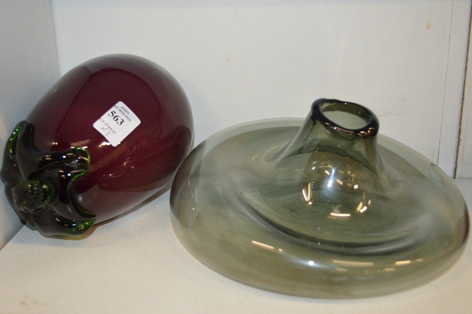 An unusual glass model of an aubergine and a misshapen glass vase.