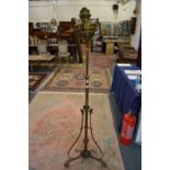 An ornate brass floor standing oil lamp.