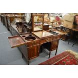 A Gillows of Lancaster gentleman's mahogany kneehole dressing table with bi-fold top and rising