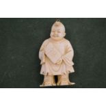 A Chinese carved figure of a boy.