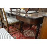 A Regency mahogany extending dining table with ratchet mechanism, two leaves on turned legs with