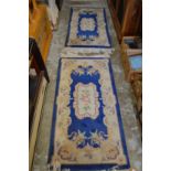 A pair of Chinese blue ground rugs.