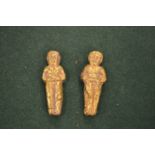 Two early gilt decorated figural amulets.