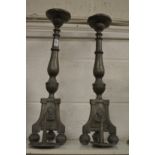 A pair of pewter pricket style candlesticks.