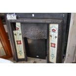 An Art Nouveau cast iron fireplace with porcelain inset tiles and later marble hearth.