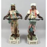 A VERY GOOD PAIR OF LARGE MAJOLICA POTTERY FIGURES OF AN ARAB MAN AND YOUNG GIRL standing holding