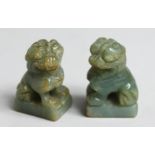 A SMALL PAIR OF CHINESE CARVED JADE FO DOGS, 1.75ins high.