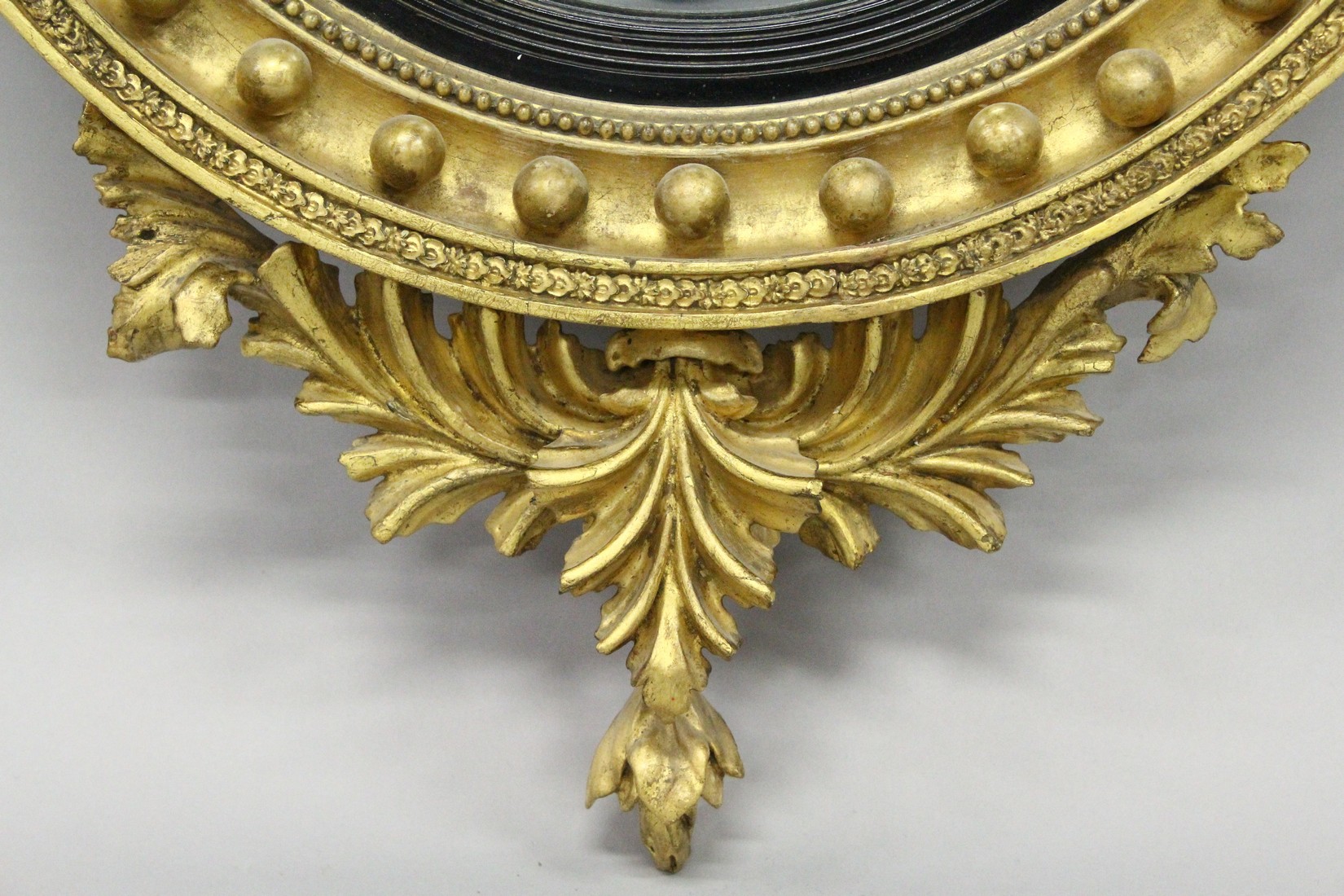 A REGENCY GILT WOOD CONVEX MIRROR with eagle cresting, ball applied frame and curved decoration to - Image 3 of 4