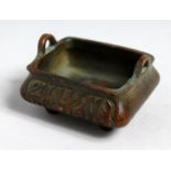 A SMALL BRONZE TWIN HANDLED CENSOR with Arabic script to the sides. 3ins wide.