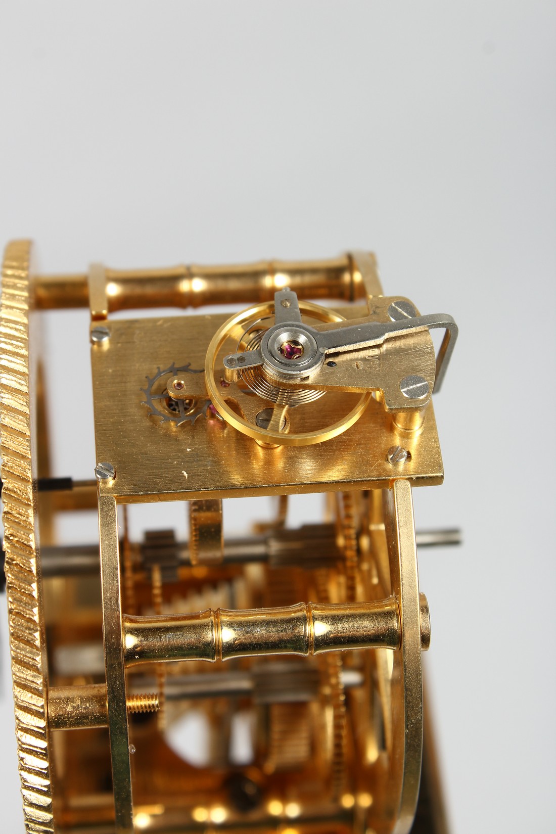 AN UNUSUAL BRASS COLUMN CLOCK with enamel dial, large spring driven movement, under a glass dome. - Image 2 of 4