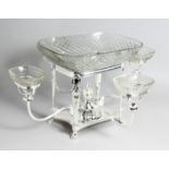 AN IMPRESSIVE SILVER PLATED AND CUT GLASS CENTRE PIECE, with central rectangular glass dish and four