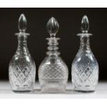 A PAIR OF CUT GLASS SHERRY DECANTERS AND STOPPERS and ANOTHER. (3).