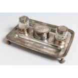 A SILVER INKSTAND by H WOODWARD & CO., London, 1913, with two silver top cut glass inkwells and oval