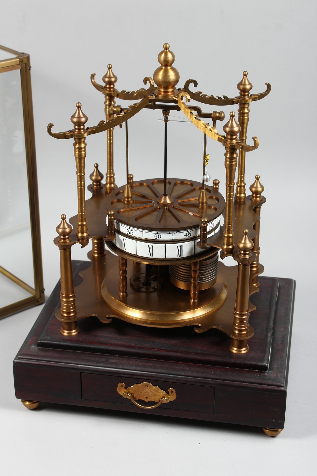 AN UNUSUAL TABLE CLOCK MODELLED AS A CAROUSEL housed under a glass case with a drawer to the - Image 2 of 2