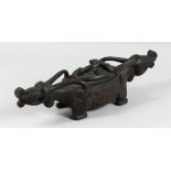 A BORNEO CARVED WOOD ZOOMORPHIC LIDDED FOOD BOWL, carved to each end with mythological beasts. 2ft