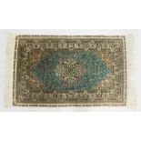 A SMALL PERSIAN SILK RUG, pale blue ground with fine floral design. 4ft x 2ft 6ins.