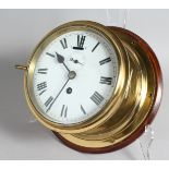 A BRASS CIRCULAR SHIP'S WALL CLOCK, 6ins dial, from the Troop Ship "Nevasa, 1913 - 1943, presented