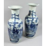 A LARGE NEAR PAIR OF CHINESE BLUE AND WHITE VASES painted with figures. 22ins & 23ins high.