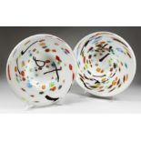 A PAIR OF LARGE MODERN CIRCULAR SHALLOW DISHES, white opaque ground with colourful decoration. 1ft