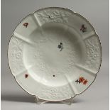 A N 18TH CENTURY CHELSEA GOTZKOWSKY TYPE SOUP PLATE moulded with flowers, with painted flowers and