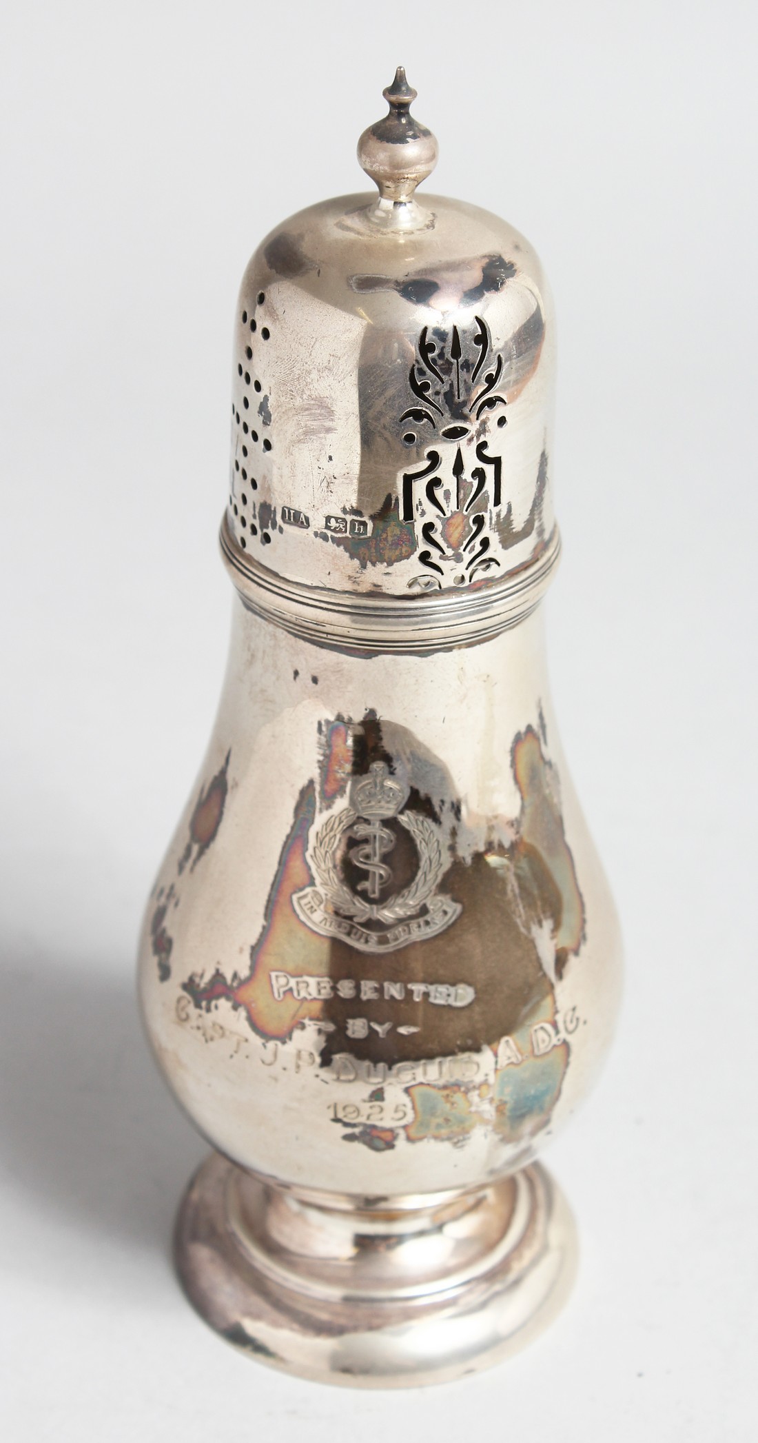 A SILVER SUGAR SIFTER, RAMC Presented by Cpt. J P. DUGUID, 1925. Sheffield, 1925, maker, Atkin Bros.