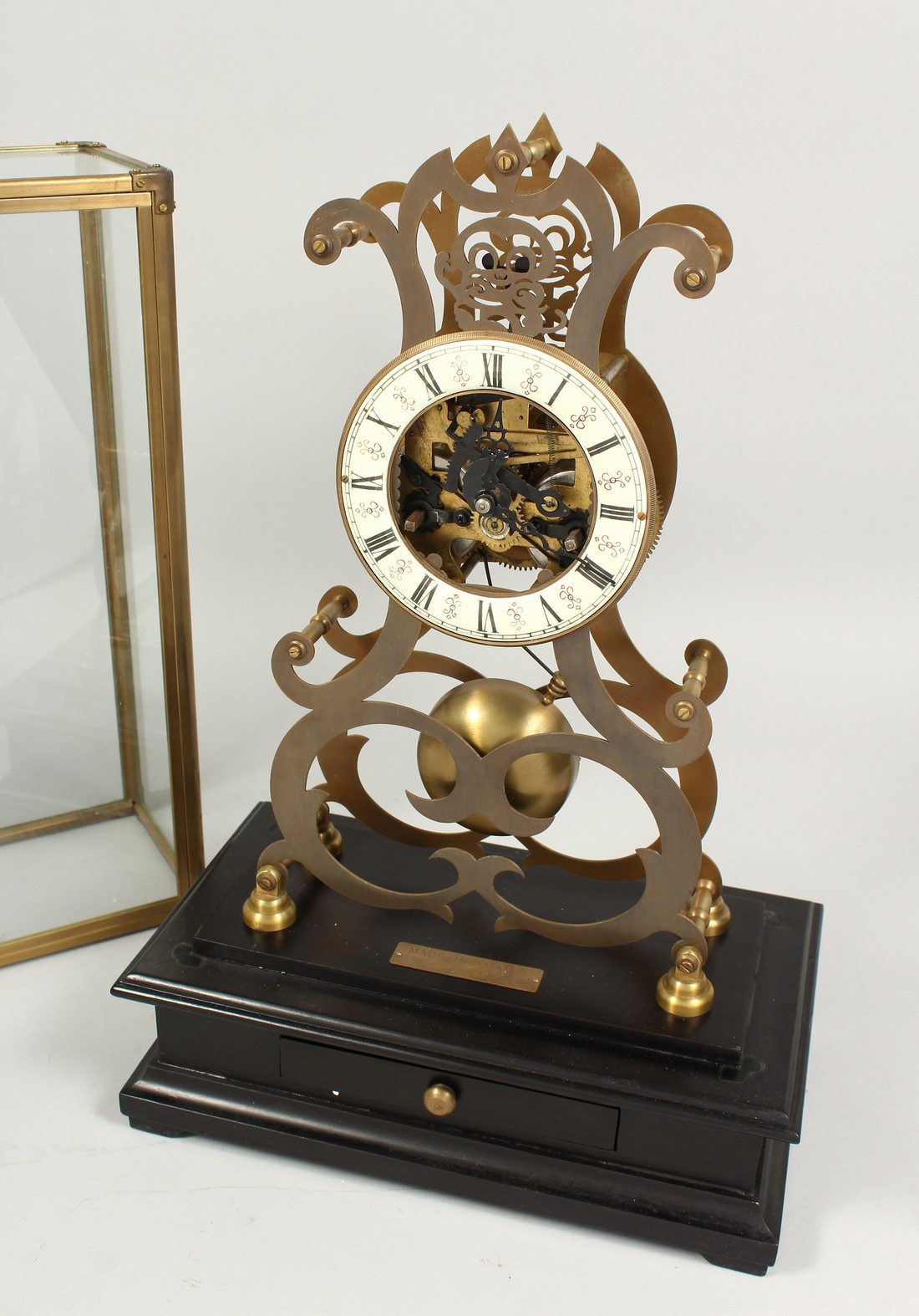 A MOONPHASE BRASS SKELETON CLOCK. 17ins in a glass case.