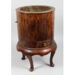 A CIRCULAR WOOD JARDINIERE on four curving legs with brass liner. 19ins high