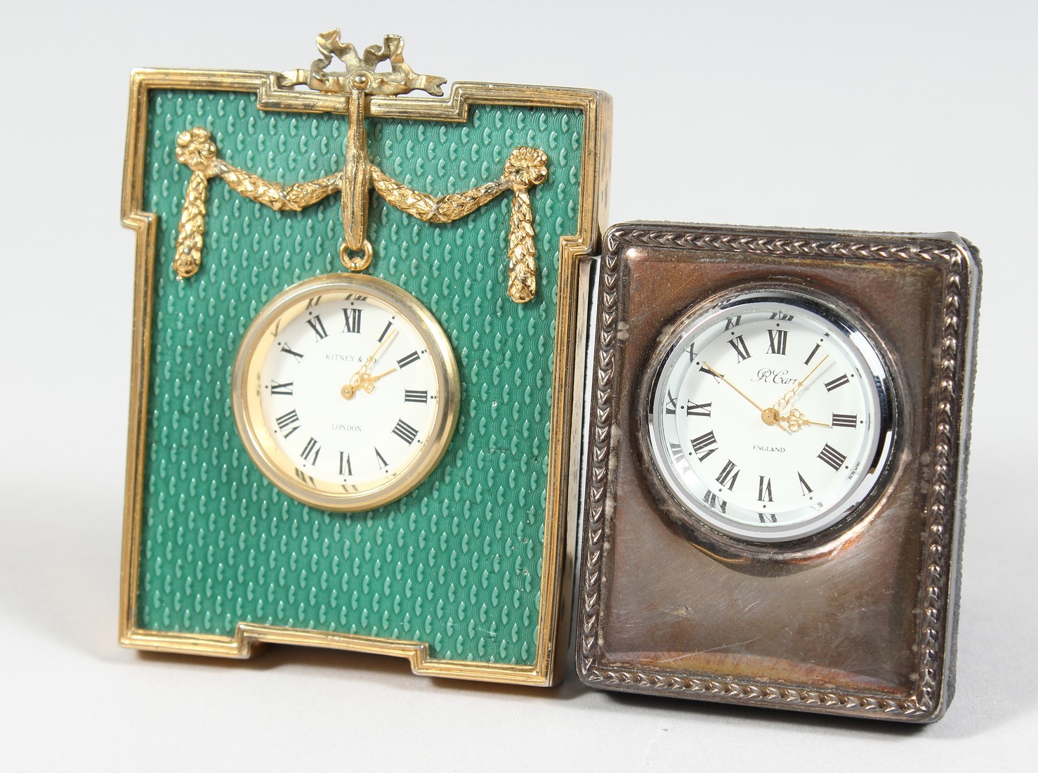 AN R. CARR SILVER CASED TRAVELLING CLOCK, 2.5ins high and another by KITNEY & CO. 3.75ins high (2).