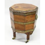 A GOOD GEORGE III MAHOGANY OCTAGONAL SHAPED CELLERETTE the rising top with carved edge, brass
