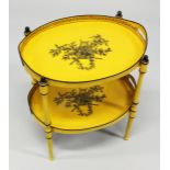 A GOOD DECORATING TOLEWARE TWO TIER OVAL ETAGERE with lift off trays, yellow ground decorated with