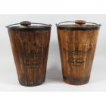 A PAIR OF WOODEN AND METAL BOUND CHAMPAGNE BUCKETS with carrying handles. 15.5ins high.