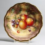 A ROYAL WORCESTER PLATE painted with fruits by SIBLEY LEWIS with gilt gadrooned border