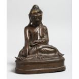 A CHINESE BRONZE SEATED BUDDHA. 6.5ins high.