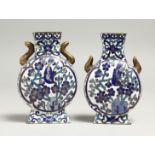 A SMALL PAIR OF CLOISONNE ENAMEL VASES, birds and foliage, 10cm high.