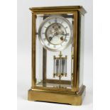 A BRASS FOUR GLASS MANTLE CLOCK with eight day movement striking on a bell, enamel dial with Roman