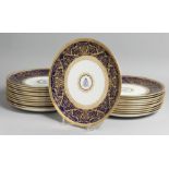A SUPERB SET OF TWENTY THREE COALPORT PLATES with A M D crest and fine blue and gold border.