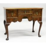 AN 18TH CENTURY WALNUT LOWBOY with a cross banded and feather banded quarter veneered top, three