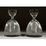 A PAIR OF CUT GLASS ROUND SCENT BOTTLES AND STOPPERS. 5.5ins high.