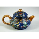 A CHINESE BLUE GROUND FAMILLE ROSE YIXING TEAPOT, the base with impressed four character mark, 11.