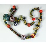 AN ISLAMIC GLASS BEADED NECKLACE, of different styles and sizes including two marvered glass