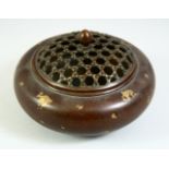 A CHINESE GOLD SPLASH BRONZE CENSER with pierced top. 4.5ins diameter.