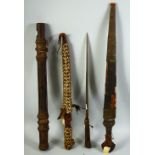 A COLLECTION OF FOUR TRIBAL WEAPONS, possibly North African, including three daggers and one darts