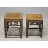 TWO GOOD CHINESE HARDWOOD SQUARE STANDS, each inset with a burr wood panel, above a carved frieze s