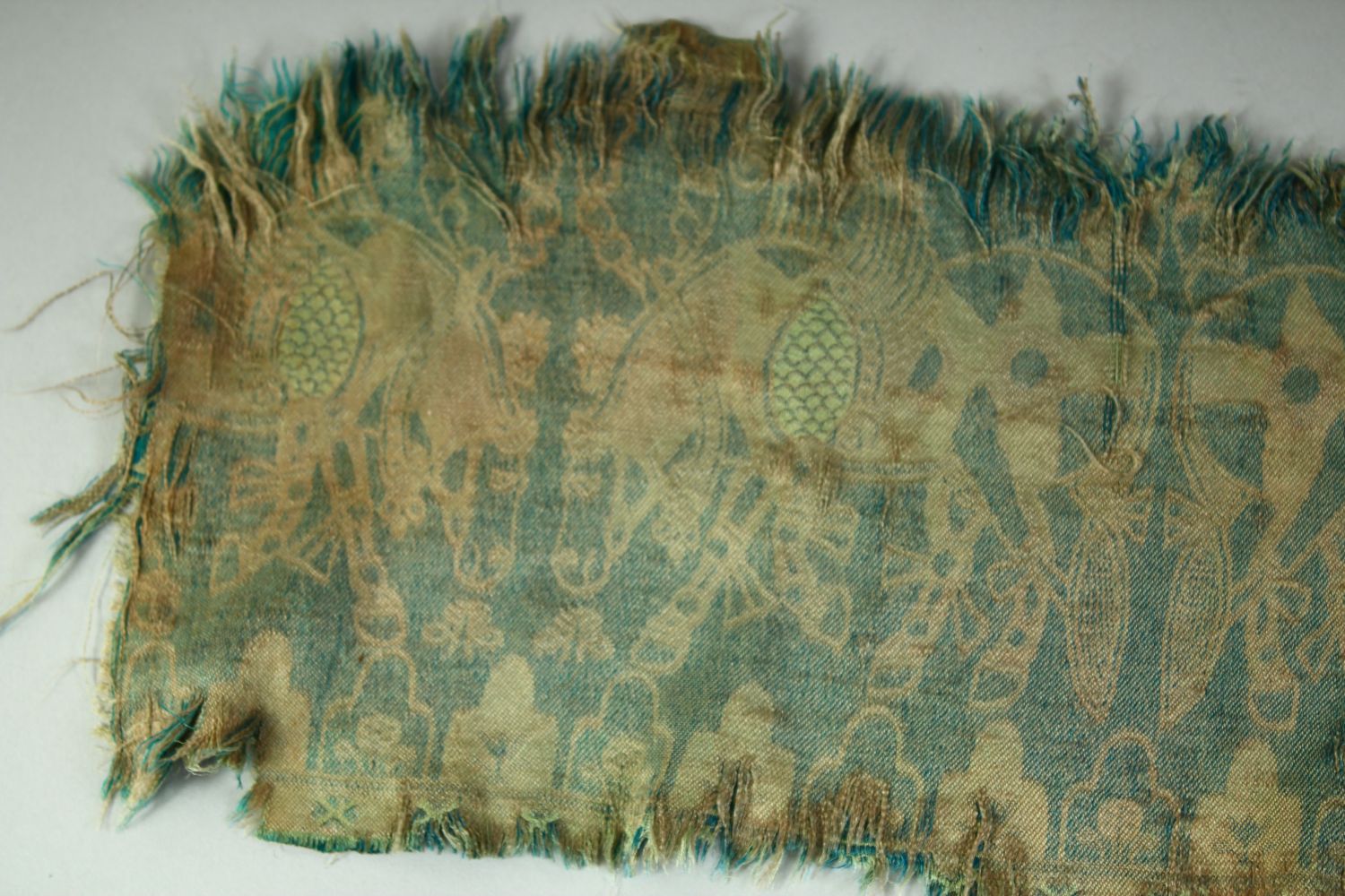 AN ISLAMIC TEXTILE FRAGMENT, embroidered with horses. - Image 8 of 8