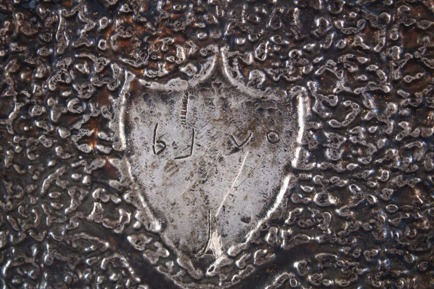 A LARGE INDIAN SILVERED BRONZE OR BRASS TRAY, with a central crest and scrolling foliate, 68.5cm x - Image 6 of 6