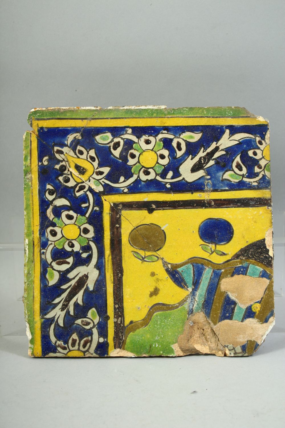 FOUR ISLAMIC GLAZED POTTERY TILES, three with foliate decoration and one with a section of a figure, - Image 5 of 5