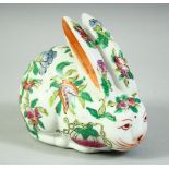 A CHINESE FAMILLE ROSE PORCELAIN RABBIT, painted with peaches and flora, 11.5cm.